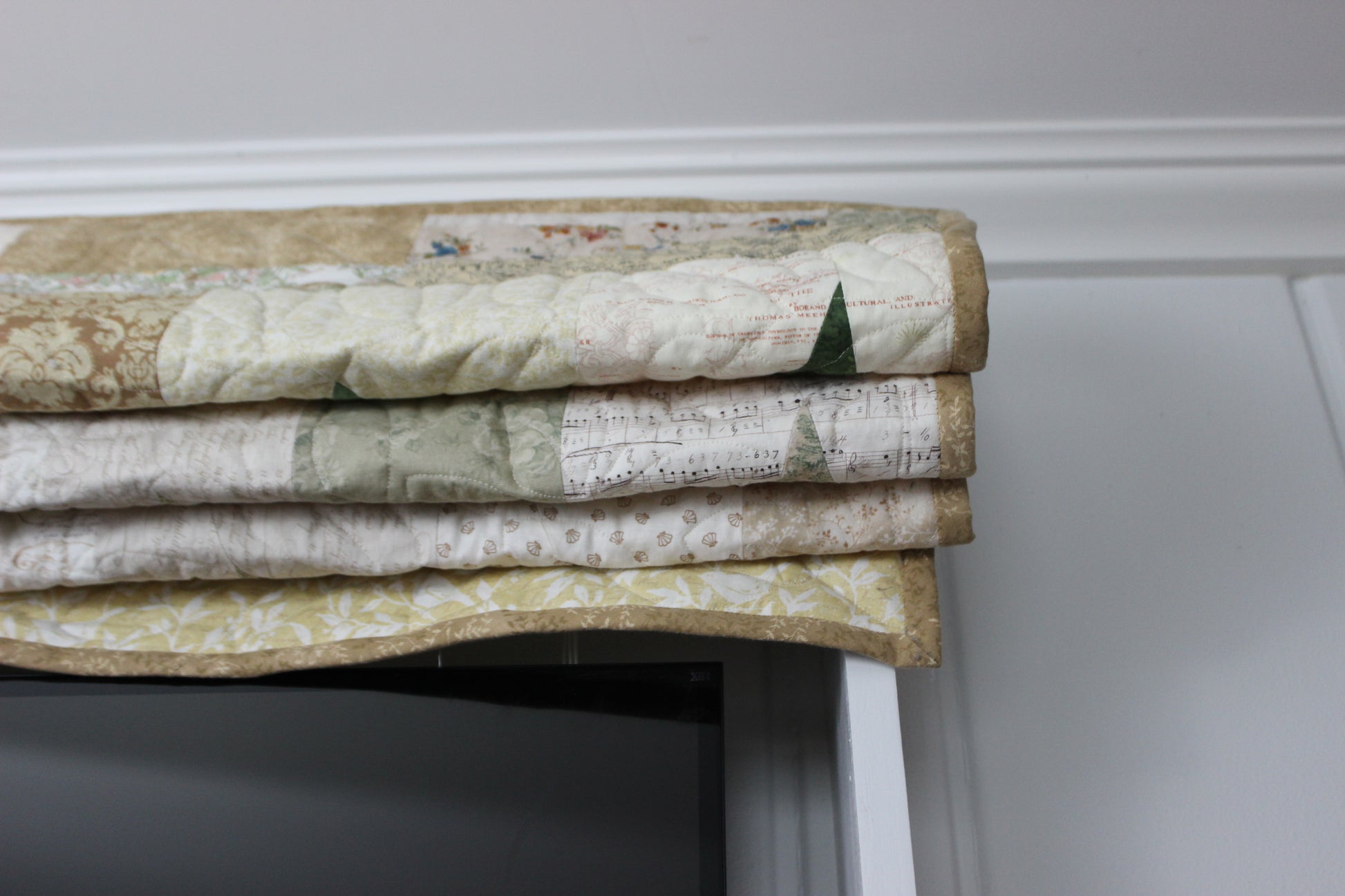 Top of quilt drawn up above TV